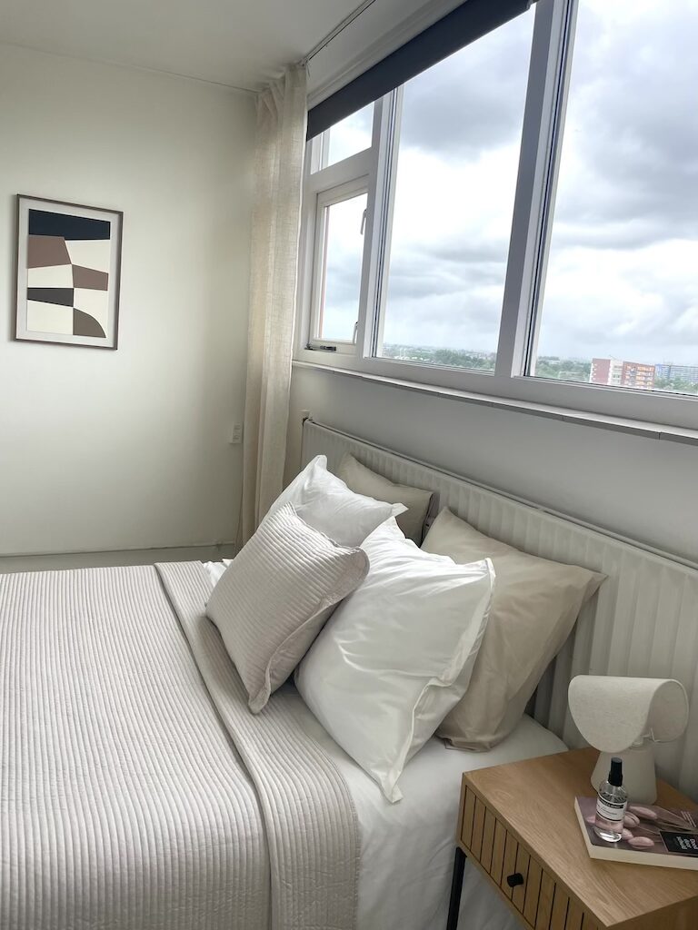 Vastgoedstyling slaapkamer met lichte inrichting en moderne wanddecoratie