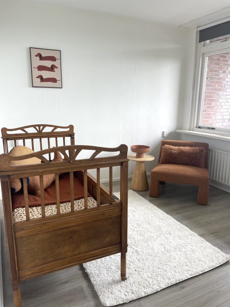Vastgoedstyling Zwolle kinderkamer met houten kinderbed en warme aardetinten