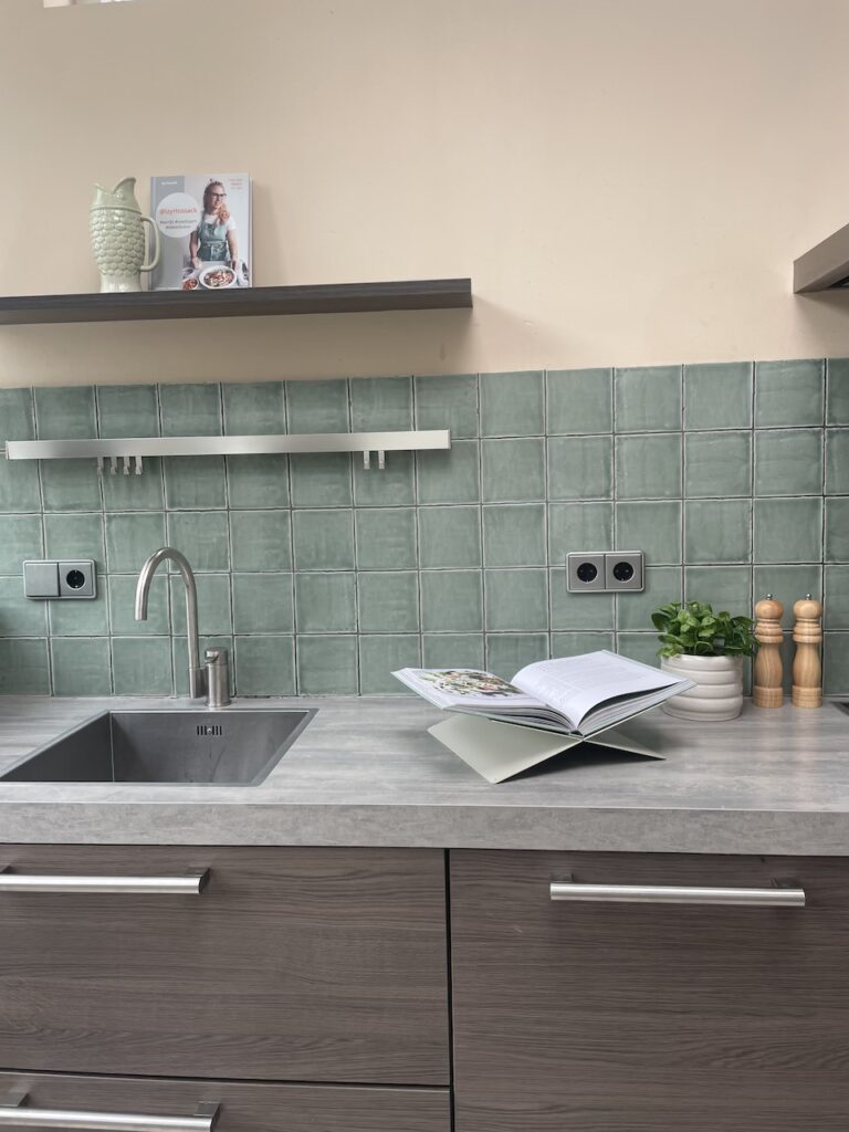 Woningstyling keuken met groene tegels en sfeervolle accessoires